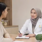 Dokter wanita berhijab berkonsultasi dengan pasien di klinik KIBM menggunakan pendekatan Functional Medicine Indonesia yang berfokus pada metabolisme, kesehatan sel, dan longevity.